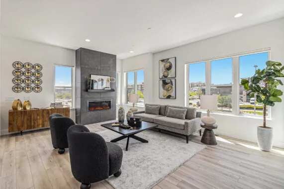 Stylish modern living room with large windows and decor.