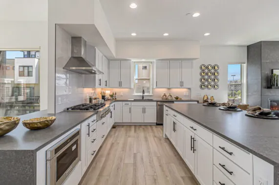 Modern kitchen with gray countertops and white cabinets