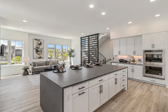 Modern kitchen and living area with large windows