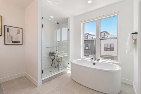 Modern bathroom with bathtub, shower, and artwork on the wall